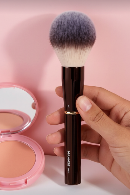 Makeup brush with pink compact on soft pink background